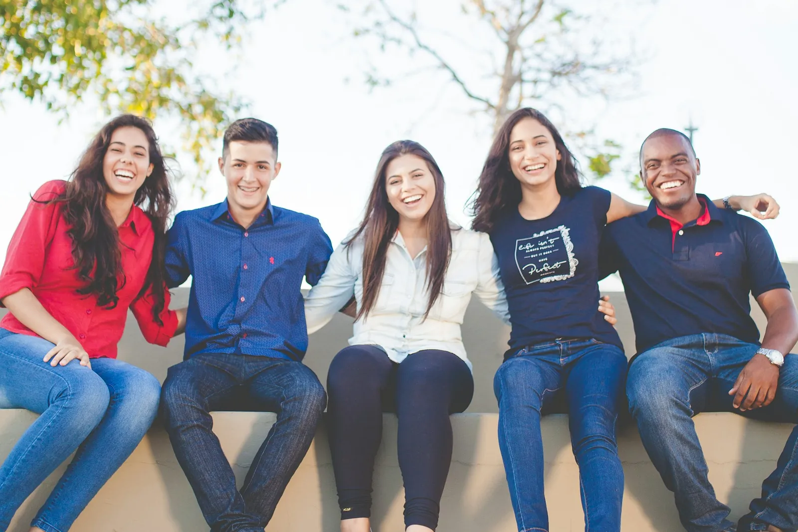 A diverse team smiling together in a sunlit space